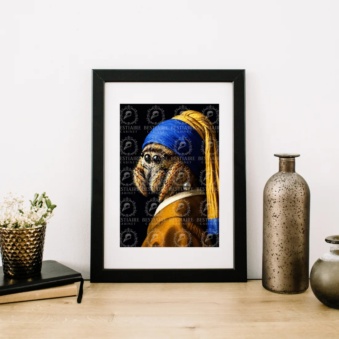 Framed spider with a pearl earring artwork